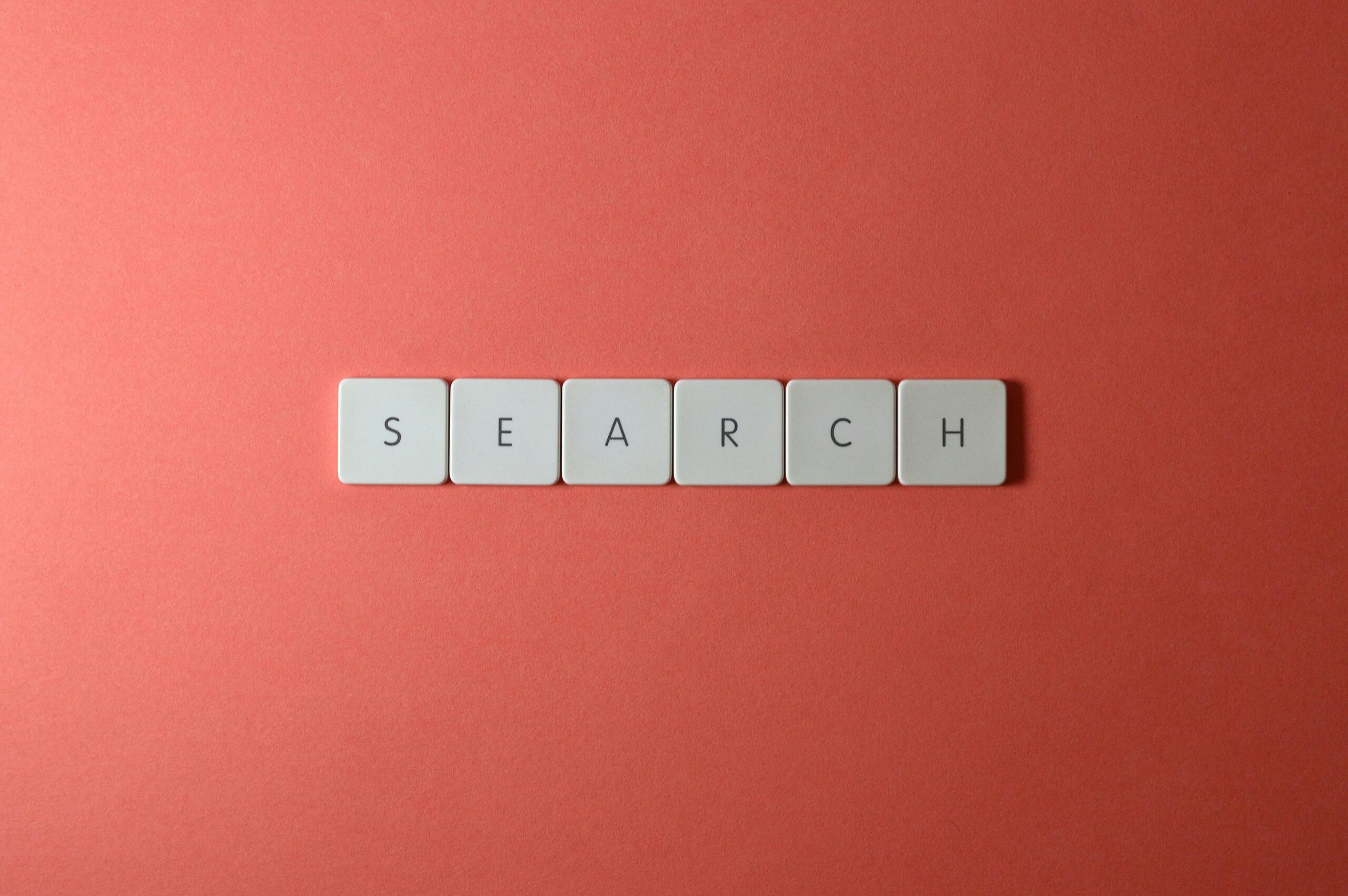 White keyboard keys spelling 'search' on a bold red surface, conceptual design with copyspace.